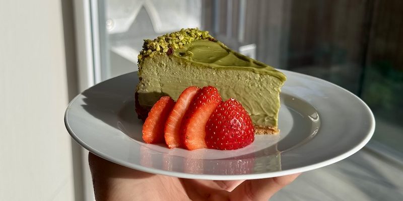 Protein pistachio cheesecake on ceramic plate